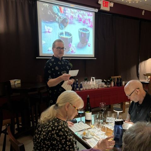 A sake tasting class in the back room, with tasting glasses and notes on the table